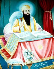 Guru Arjan Dev Ji reading from the Adi Granth